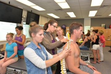 From left to right: Northern and Rural Cohort Master of Physical Therapy students Madison Morrison and Josina Rhebergen work alongside instructor Robin Roots on fellow student, Matthew Beda, during the final week of classes at UNBC
